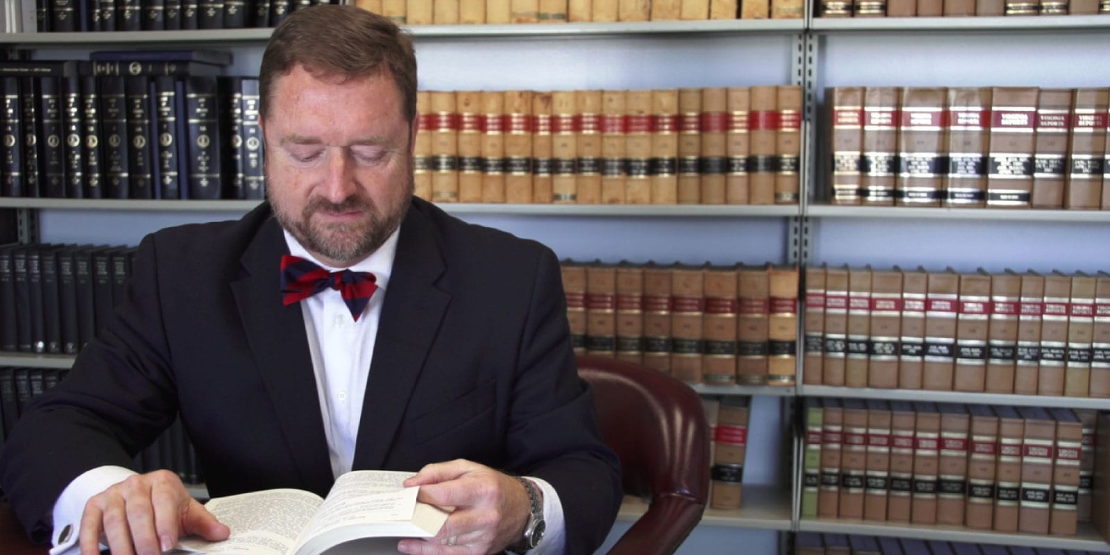 Burnett @ Williams Lawyer Reads Book at Desk