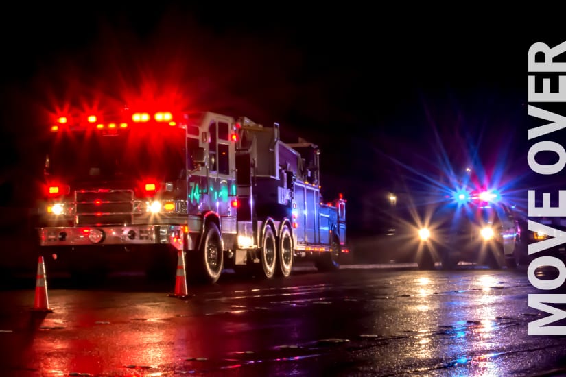 Emergency Vehicles With Lights Flashing On Highway Shoulder In Response To A Car Accident.