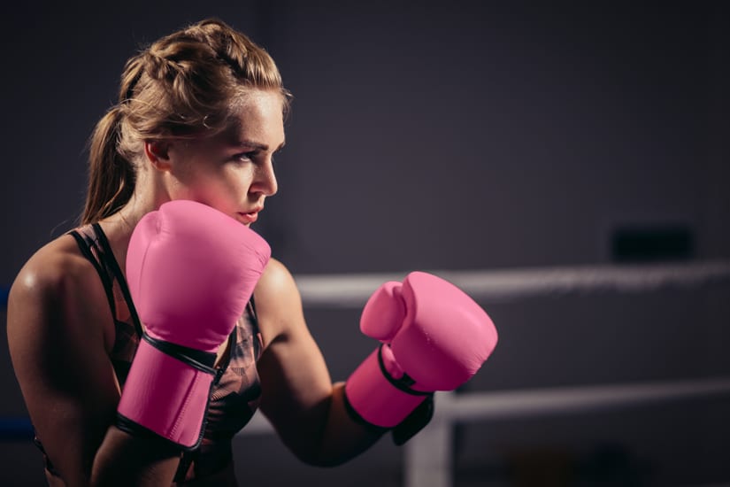 Woman in Boxing Ring Wearing Pink Boxing Gloves