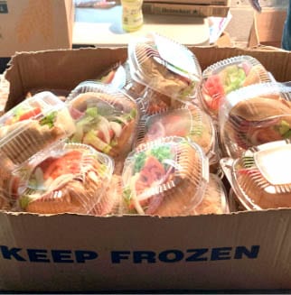 A Box Of Packaged Sandwiches To Be Handed Out At The Ampersand Food Pantry