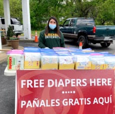 Volunteer Handing Out Diapers For The Ampersand Food Pantry