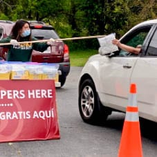 Volunteer For The Ampersand Food Pantry Handing Out Diapers